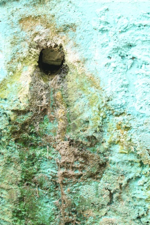 Concrete manhole cover with scraps of blue paintの写真素材