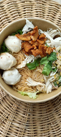Thai noodle with pork ball and fish ball in wooden bowlの写真素材