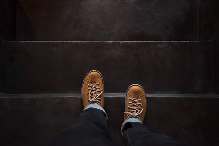 Top view, Male with Leather Shoes, Steps on Dark Black Concrete Stair, Start and Forward Conceptの写真素材