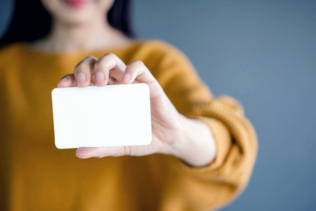 Woman holding blank business card for mock upの写真素材