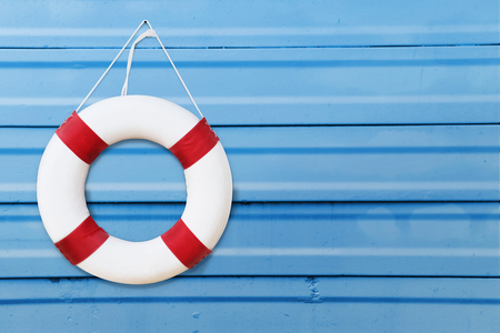 Life guards red and white rescue ring buoy hanging on Blue wall at the poolの写真素材