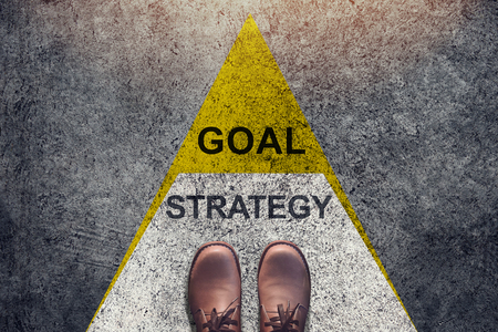 Strategy and Goal concept, Shoes stand over Triangle level Shape , Top view and Dark tone, Grunge Dirty Concrete Floor as Backgroundの写真素材