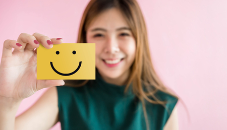 Customer Experience Concept, Happy Woman Show Excellent Rating with Smiley Face icon for her Satisfaction on Card の写真素材