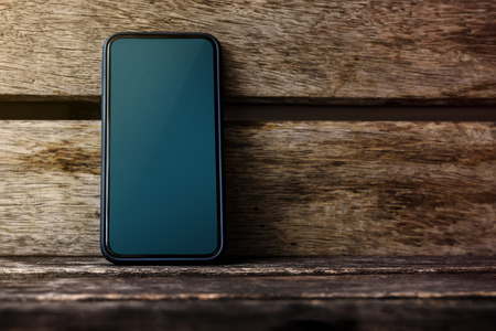 Mobile Phone Mockup Image, Blank Display Screen as Clipping Path, Smart Phone on Old Wooden Desk, Front Viewの写真素材