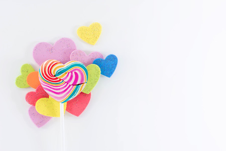 Love and Valentines Day Concept. Heart Sweet Lollipop Candy Lay on White background with many Colorful heart shape, Varieties of Genderの写真素材