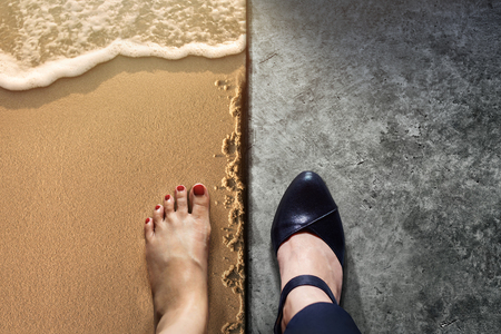 Life Balance concept for Work and Travel present in Top view position by half of Business Working Woman Shoes on Cement Floor and Female's Barefoot on Sand Beachの写真素材