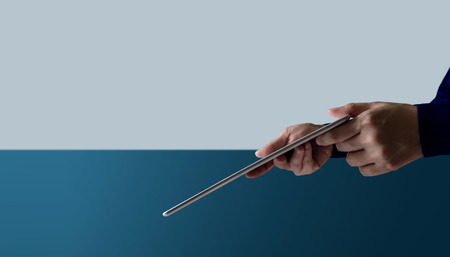 Hand holding a Digital Tablet. Side View