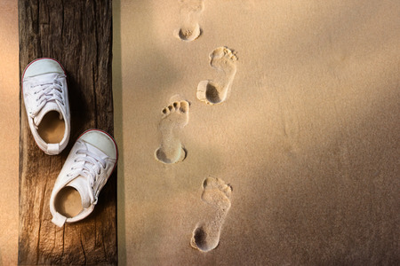 Children Learn Beyond Classroom Concept, Kids Shoes Lay on the Wooden Timber, Sand Beach with...