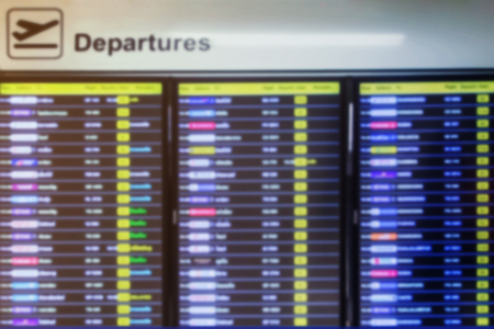 Blurred of flight information on departures board in airportの写真素材