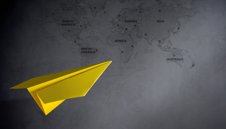 Travel Concept. Paper Airplanes Flying over the Cement Wall, Blurred World Map as background, Dreaming Destination and Planing for the Next Vacationの写真素材