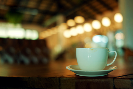 Coffee Cup on the Table in Cafe. Blurred Lights in bar as backgroundの写真素材