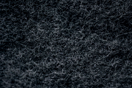 Dark Abstract Texture Background. Black Sponge Net in Macro Closeup Shotの写真素材