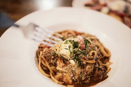 Eating Spaghetti Beef Sauce in Restaurant at Night.Selective Focusの写真素材