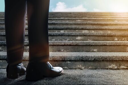 Motivation and Challenging in Career. Successful Concept. Low Section of Businessman Standup on Staircase. Get Ready to Moving Forward. Male in Black Formal Dressの写真素材