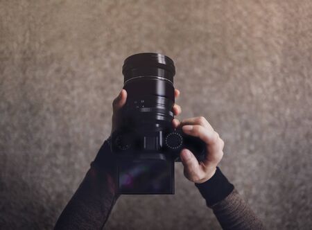 Young Photographer Woman using Camera to Taking Photo. Dark Tone, POV or Top View in Low Angle. Selective focus on LCD Screenの写真素材