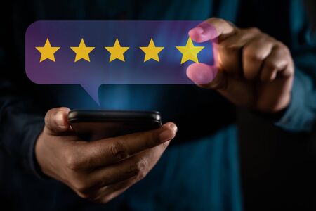 Customer Experiences Concept. a Modern Man Giving Five Stars Rating, Positive Review via Smartphone....