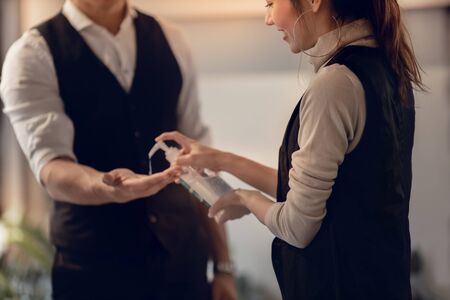 Covid-19 or Corona Virus Situation in Business Concept. Business People Keep Hand Clean with an...