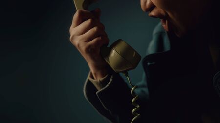 Angry Person Shouting to the Retro Telephone. Cropped image, Vintage Colour Toneの写真素材