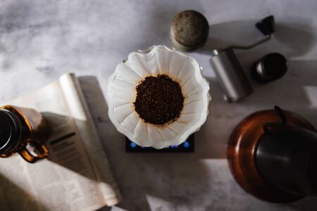 Coffee Drip Concept. Home Brew. Coffee Equipment Lay on the Cement Table. Top View with Natural Sunlight in the Kithchenの写真素材