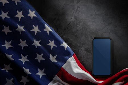 4th of July or Memorial Day of United States Concept. Blank Mobile Screen for Mockup. USA Flag Lying on Cement Background. American Symbolic. Top Viewの写真素材