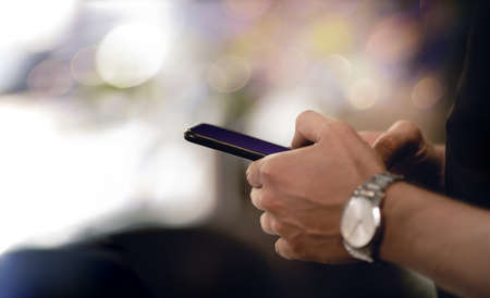 Man Using Mobile Phone. Closeup shot. plenty of Copy Space. selective focus on Smartphone