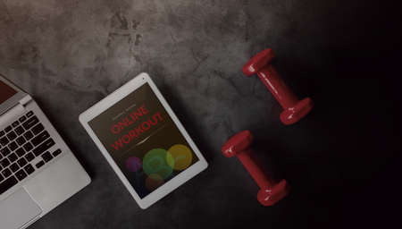 Online Workout Concept. Laptop, Dumbbell and Tablet Lay on Cement Floor at Home. get Ready to Exercising. Top Viewの写真素材