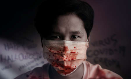 Halloween in Covid-19 Situation Concept. Person Wearing a Surgical Mask as Make-up and Paint with...
