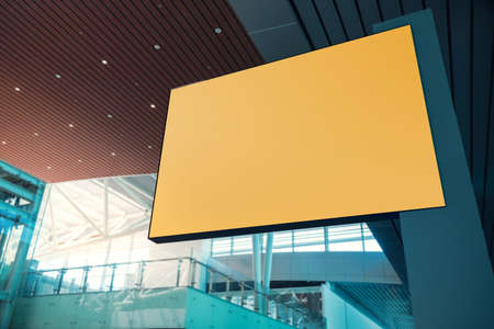 Blank Board for Mockup. Empty Yellow Horizontal Poster. Indoor Scene in Modern Public Building. Clipping Path Includedの写真素材