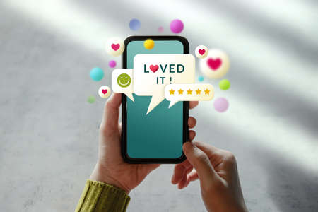 Customer Experiences Concept. Woman Using Mobile Phone to Giving Feedback via the Internet. Positive Review. Client Satisfaction Surveysの写真素材