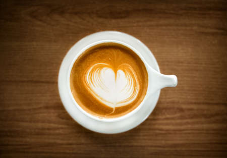Hot Coffee Latte Cup on Wooden Table. Top Viewの写真素材