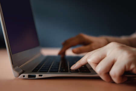 Young Woman Working on Computer Laptop. Closeup shot and selective focus on Fingerの写真素材
