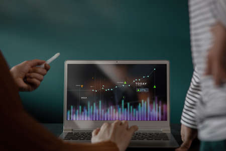 Small Business Teamwork Working Together on Laptop. Stock Market Data Analysis show on Computer...