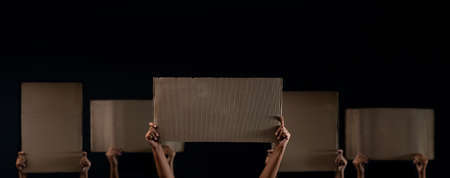 Protest , Mob or Expression Concept. Group of People Raised a Blank Corrugated Paper. Speech Template Texture Background. Front View and Dark toneの写真素材