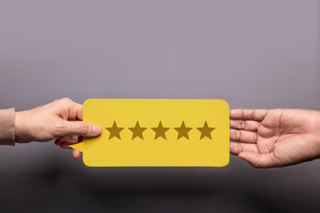 Customer Experience Concept, Happy Client giving a Feedback Card with Five Star Rating to a Businessman. Top Viewの写真素材