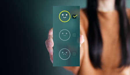 Customer Experiences Concept. Happy Client giving Excellent Rating Feedback on Card to Brand. Positive Review. Satisfaction Survey. Marked on Smiling Emoticonの写真素材