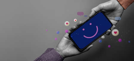Customer Experience Concept. Happy Client giving a Smiling Emoticon via Mobile Phone to Brand....
