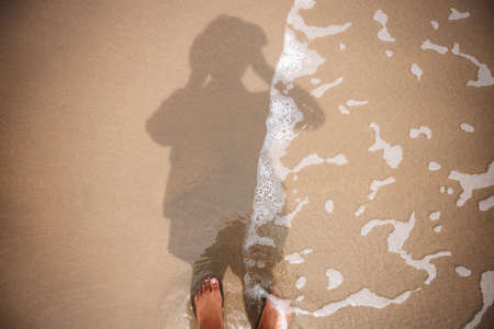 Photographer Taking Self Portrait by Reflection Shadow on Beach Sand. Top View. Summer Vacation....