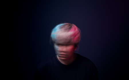 Conceptual Motion Blurred Photo of Crazy Person. Bipolar Disorder. Mental Health and Psychology Concept. Different of Emotionsの写真素材