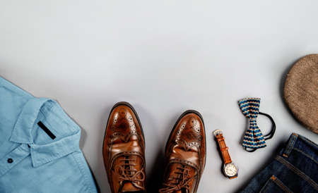 Men Clothes, Father Day Concept. Vintage Style. Flat Lay on Light Grey Background.Included Wingtips Dress Shoes, Hand Watch, Bow Tie, hat, Shirt, Jeans and Sunglasses . Stylish Men. Top Viewの写真素材