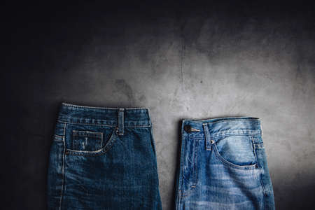 Jeans Pant lay on Cement Floor. Fashion, Clothes for any Gender, Classic Wearing for Diversity. Top View, Dark toneの写真素材
