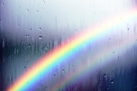 Rainy Day Concept. Rainbow as Outsdie. Water Droplet Texture Background, Rain Drops on Glass Windowの写真素材