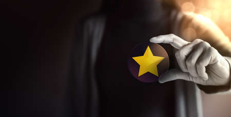 Success in Business or Personal Talent Concept. Young Employee Woman Holding a Golden Starの写真素材