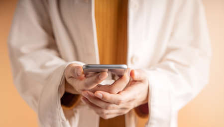 Closeup of Hand Using Mobile Phone. Cropped image. Selective Focus. Using Smartphone for...