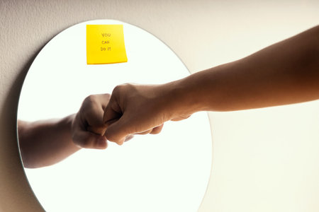 Growth Mindset Concept. Person making a Self Encouragement by Fist Bump and You Can Do It Sticky Note on Mirrorの写真素材