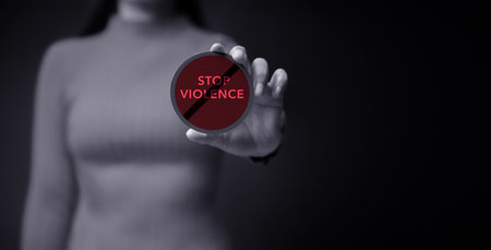 Protest and Expression Concept. Young Women Raised a Word of Stop Violence.  Front View and Dark Dramatic toneの写真素材