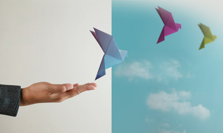 Peace, Hope concepts. World International Peace Day. Hand Released a Paper Origami White Dove into...