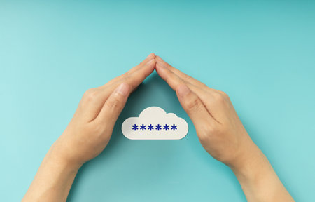 Hands shielding password on cloud symbol, representing Cybersecurity, data privacy, and online protection. Top Viewの写真素材