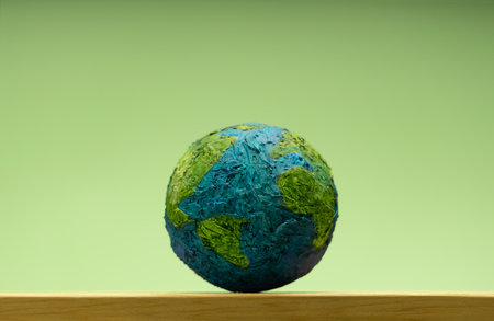 Green Globe on Green background. Environmental sustainability, Earth Day, global ecological care and Healthy planetの写真素材