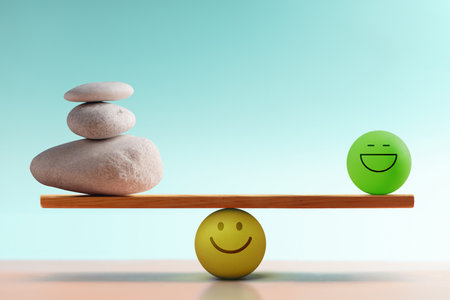 Pebble Stone and Smiling Ball balancing on seesaw, Mental Health and Emotional self regulation through balancing Relax positive and Anxiety negative emotionsの写真素材