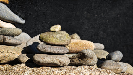 Stacked stones in perfect balance, symbolizing meditation, patience, and harmony in Zen philosophy...